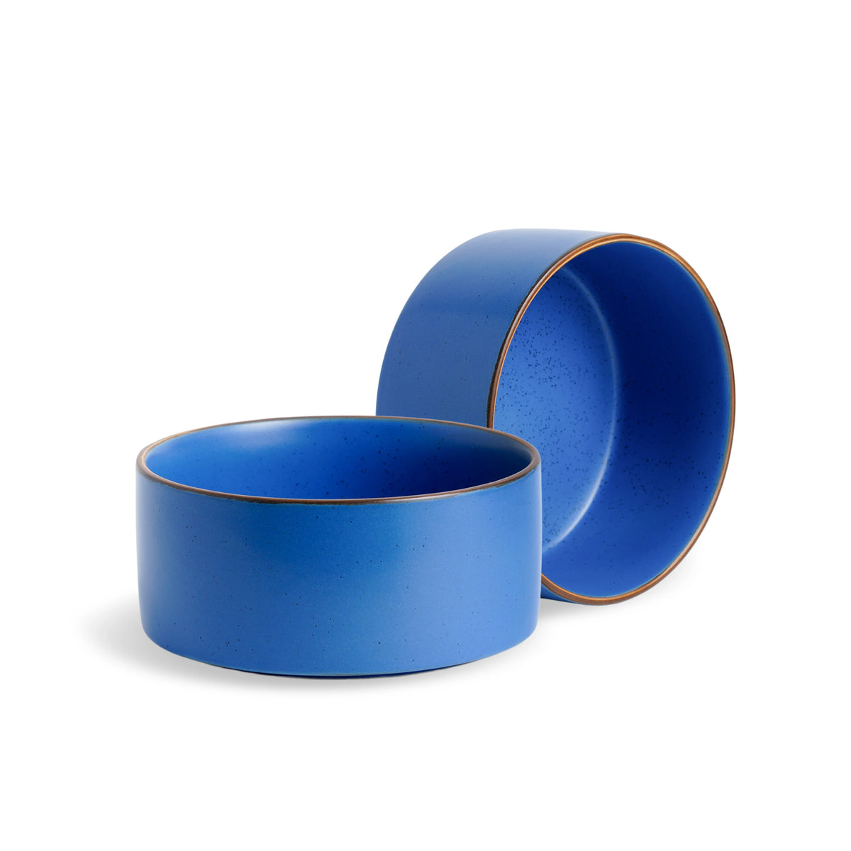 Two blue ceramic bowls with gold rims on a white background