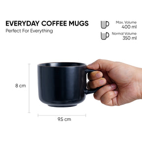 Black coffee mug held by a hand with measurements and volume details on a white background
