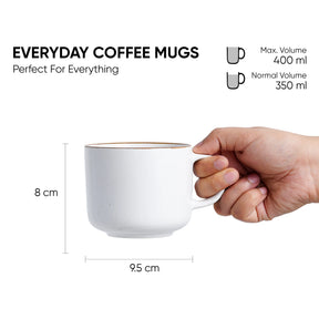 Hand holding a white coffee mug with dimensions and volume information on a white background