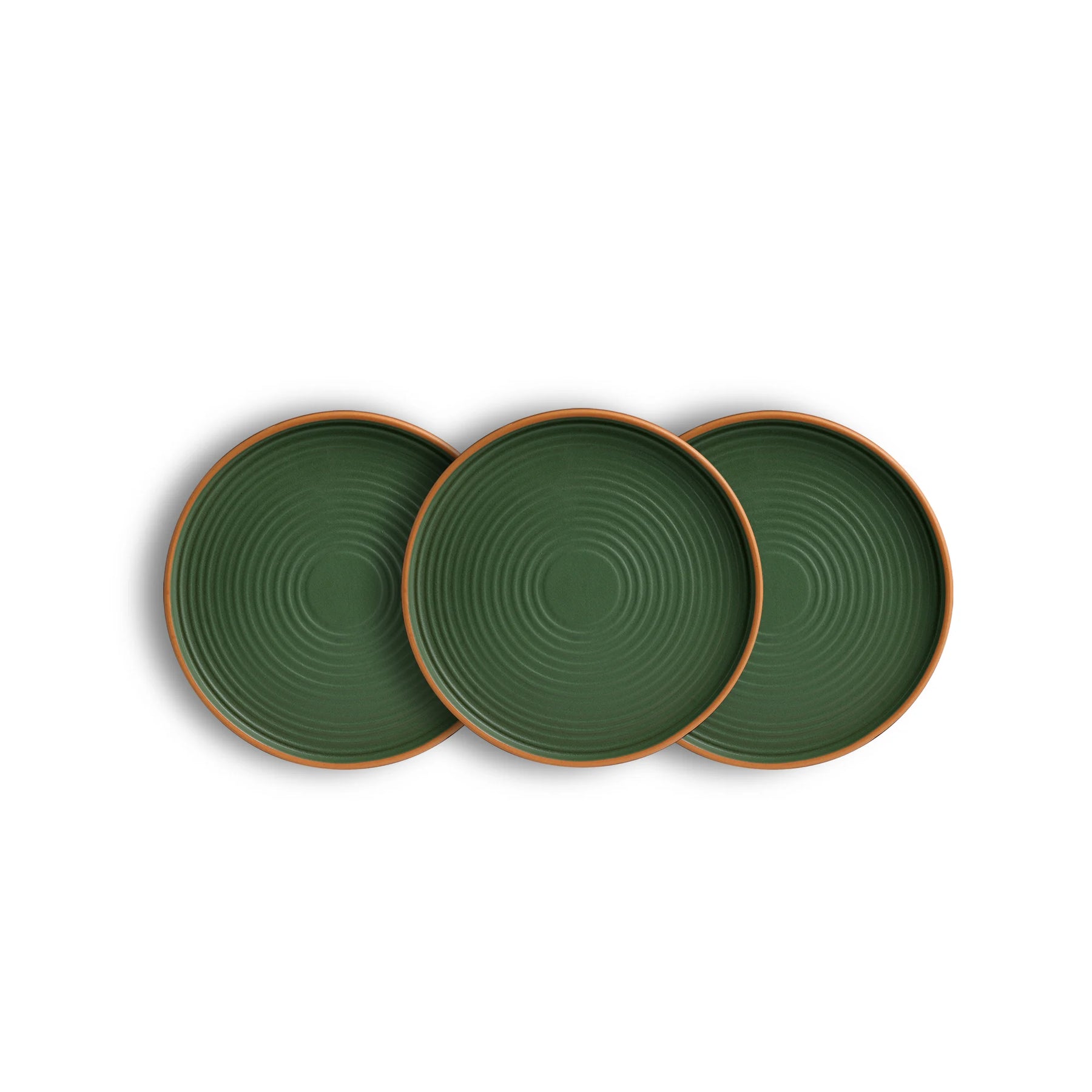 Three green ceramic plates with brown rims on a white background