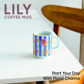Colorful coffee mug with floral design on a white surface, featuring the brand 'LILY'.