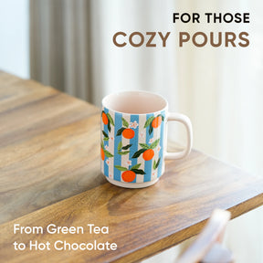 Mug with floral design on a wooden table, text 'For those cozy pours' and 'From Green Tea to Hot Chocolate'.