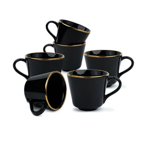 Set of black mugs with gold rims on a white background