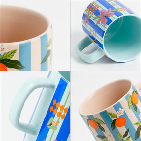 Set of four mugs with different patterns on a white background