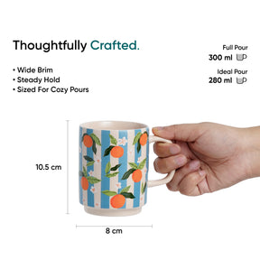 Mug with orange design held by a hand, labeled 'Thoughtfully Crafted' with measurements and pouring details.