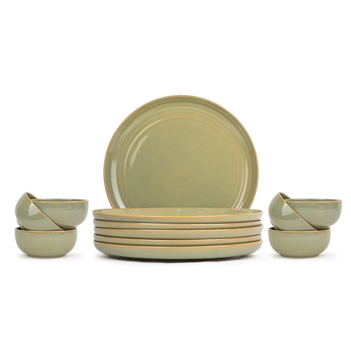 Set of green ceramic dinnerware including plates and bowls on a white background