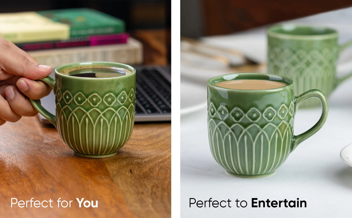 Green ceramic mug with decorative patterns held by a hand and placed on a table.