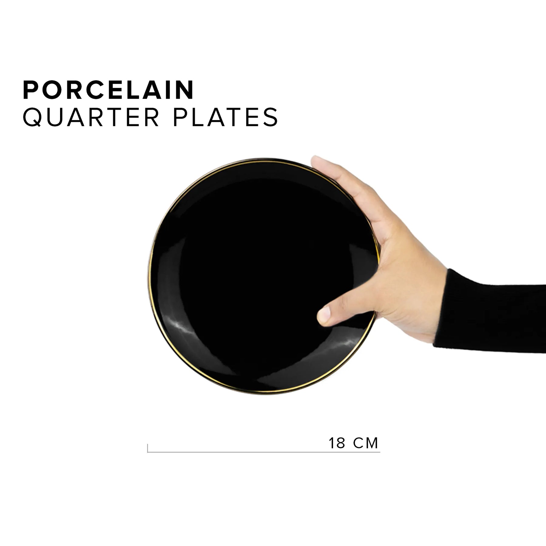 Hand holding a black porcelain quarter plate with gold rim on a white background