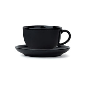 Black ceramic cup and saucer set on a white background