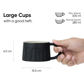 Black mug held by a hand with measurements and volume details on a white background
