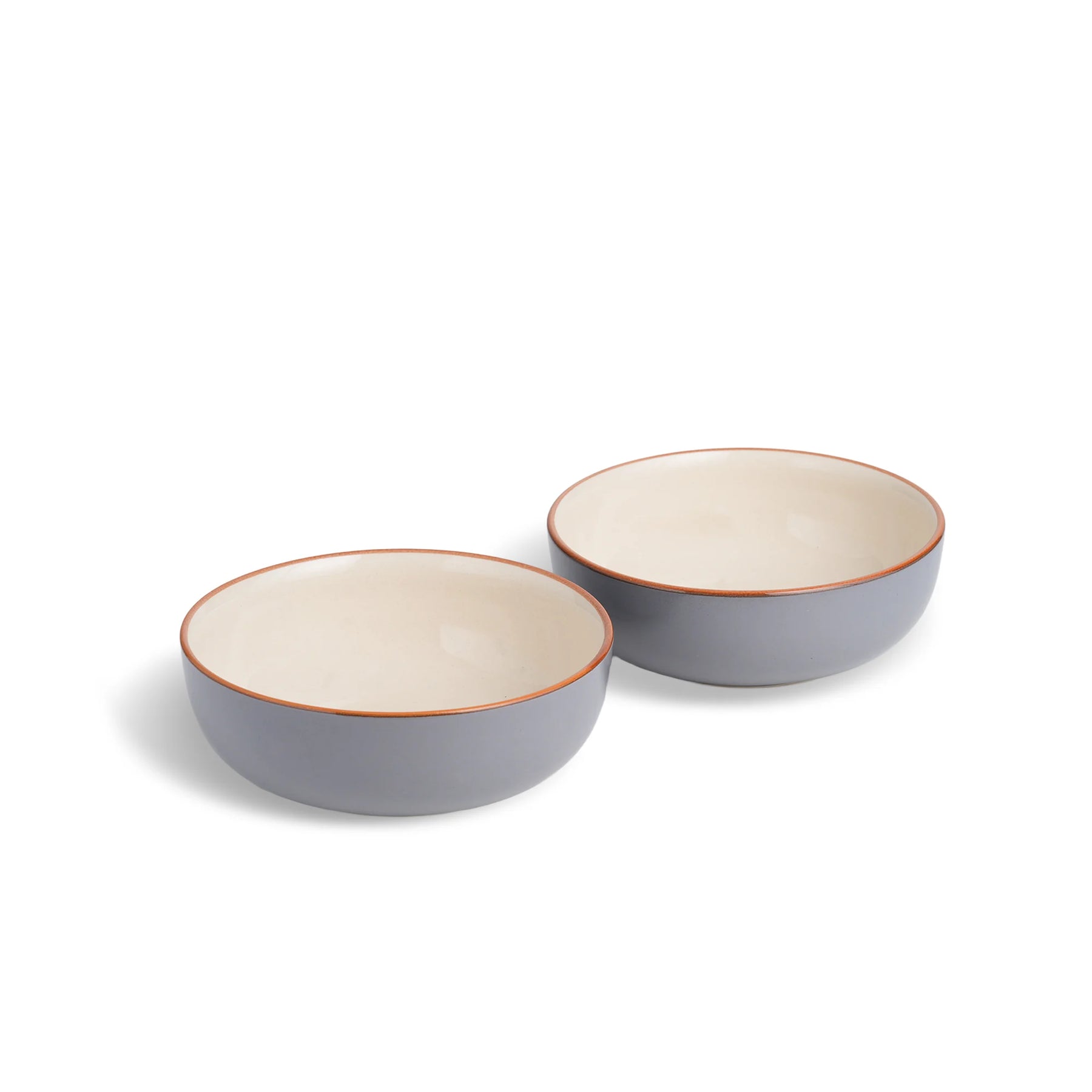 Two ceramic bowls with a gray exterior and beige interior on a white background