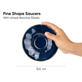 Hand holding a blue ceramic saucer with text about unique reactive glazes.