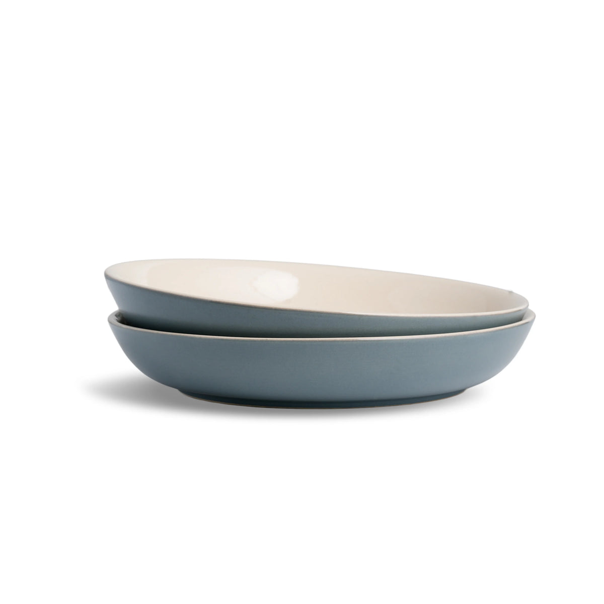 Two blue ceramic bowls stacked on a white background