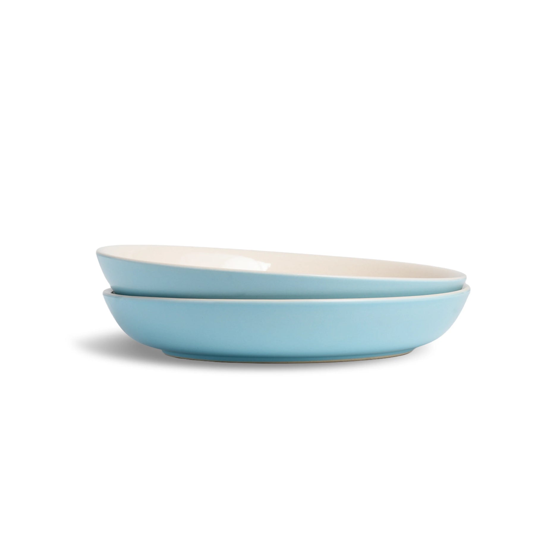Two light blue bowls stacked on a white background