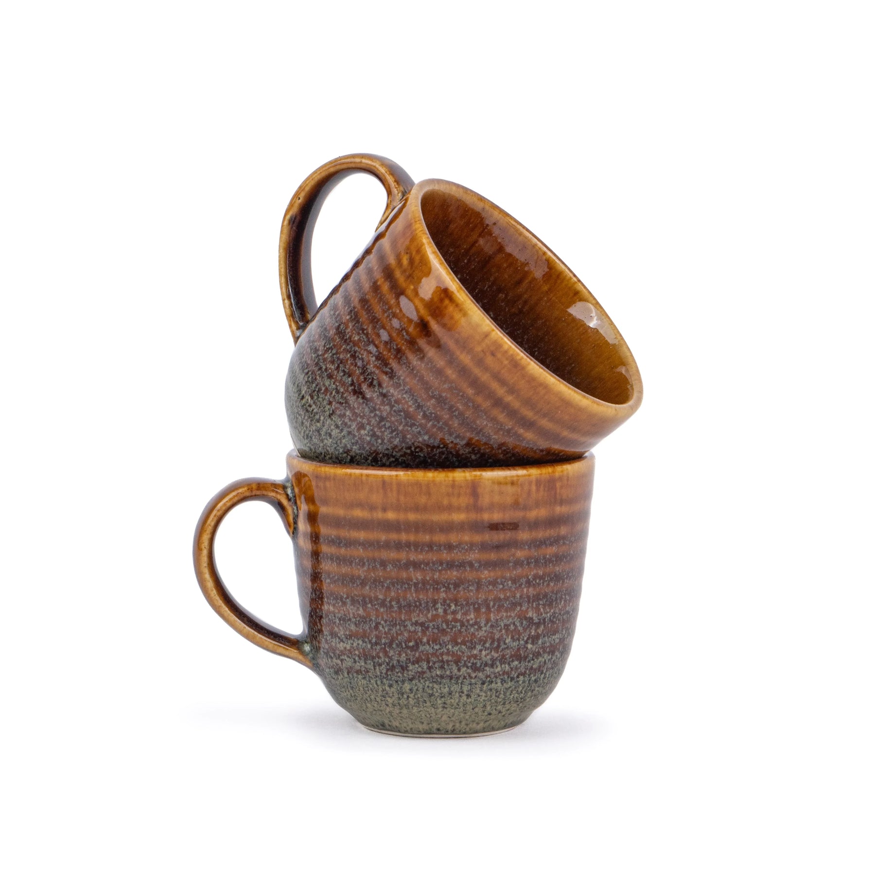 Two brown ceramic mugs stacked on a white background