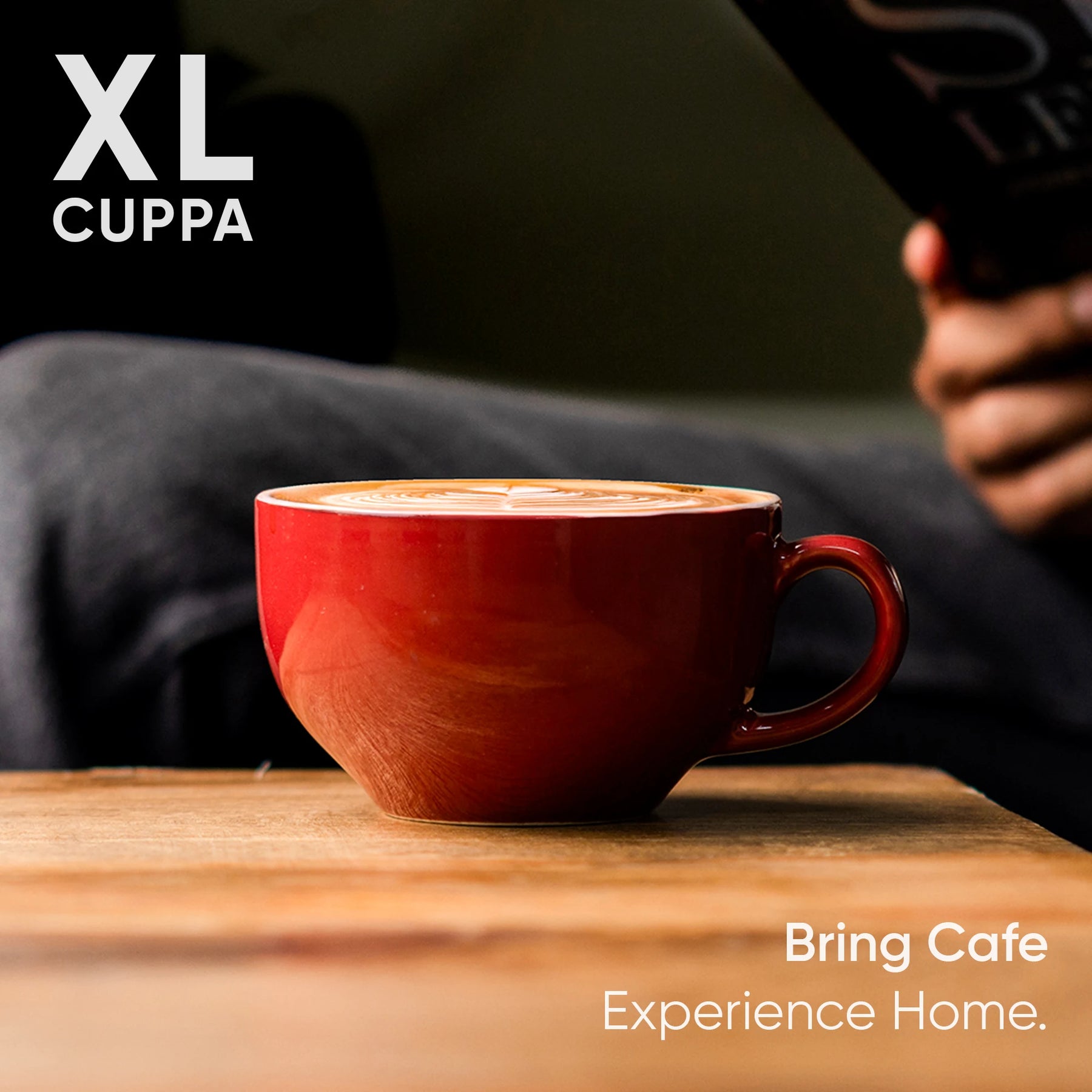 Red mug of coffee on a wooden table with 'XL Cuppa' branding and text.