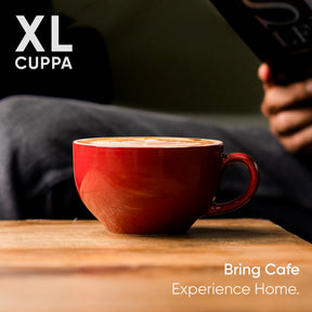 Red mug of coffee on a wooden table with 'XL Cuppa' branding and text.
