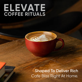 Red mug with latte art on a wooden table, featuring 'Elevate Coffee Rituals' text.