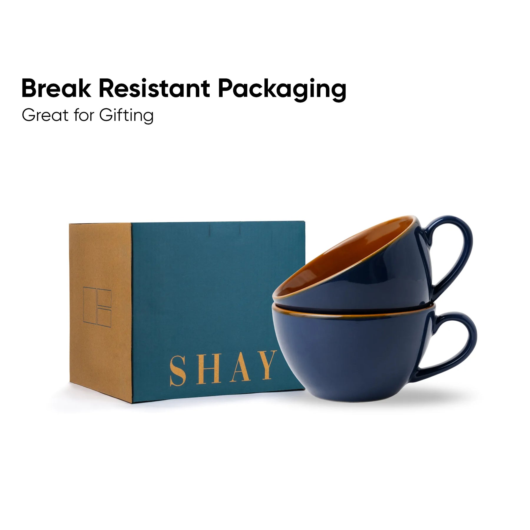 Two navy blue cups with gold interior and handles on a teal box labeled 'SHAY'. Text 'Break Resistant Packaging Great for Gifting' above.