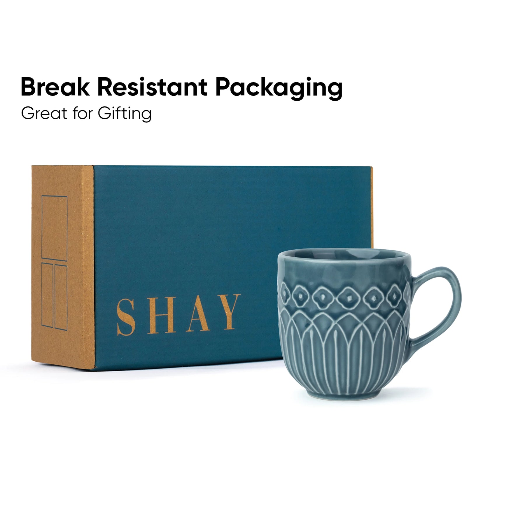 Blue mug with decorative patterns next to a teal box labeled 'SHAY' on a white background.