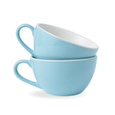 Two light blue ceramic cups stacked on a white background