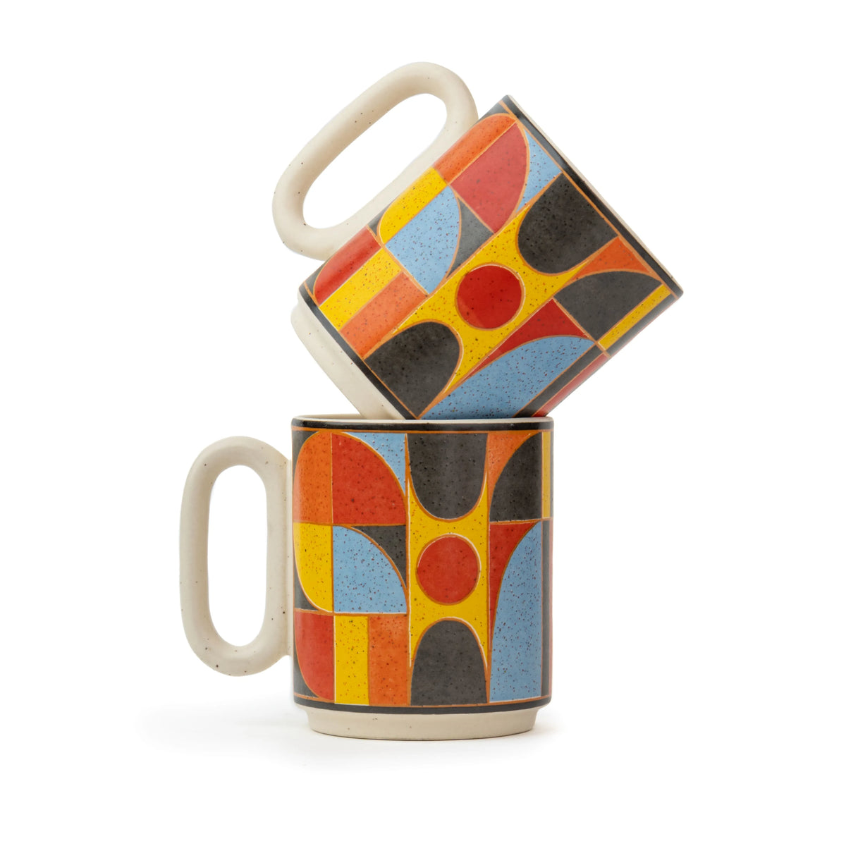 Two ceramic mugs with geometric pattern stacked on a white background