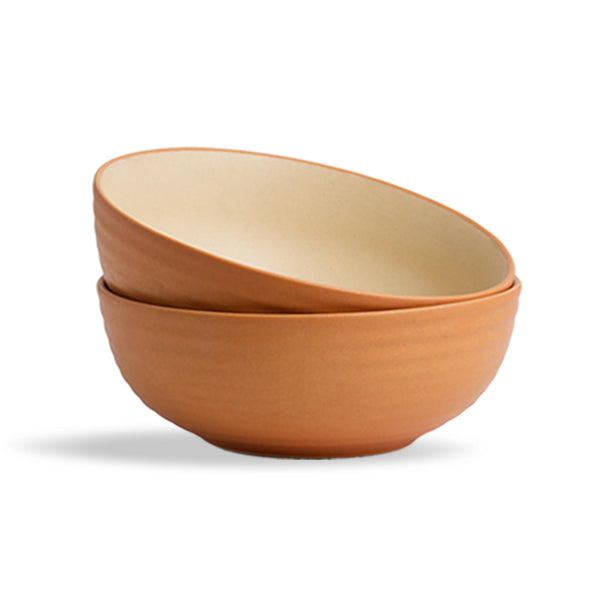Two terracotta bowls stacked on a white background