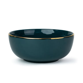 Dark blue ceramic bowl with gold rim on a white background