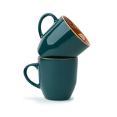 Two teal mugs stacked on a white background