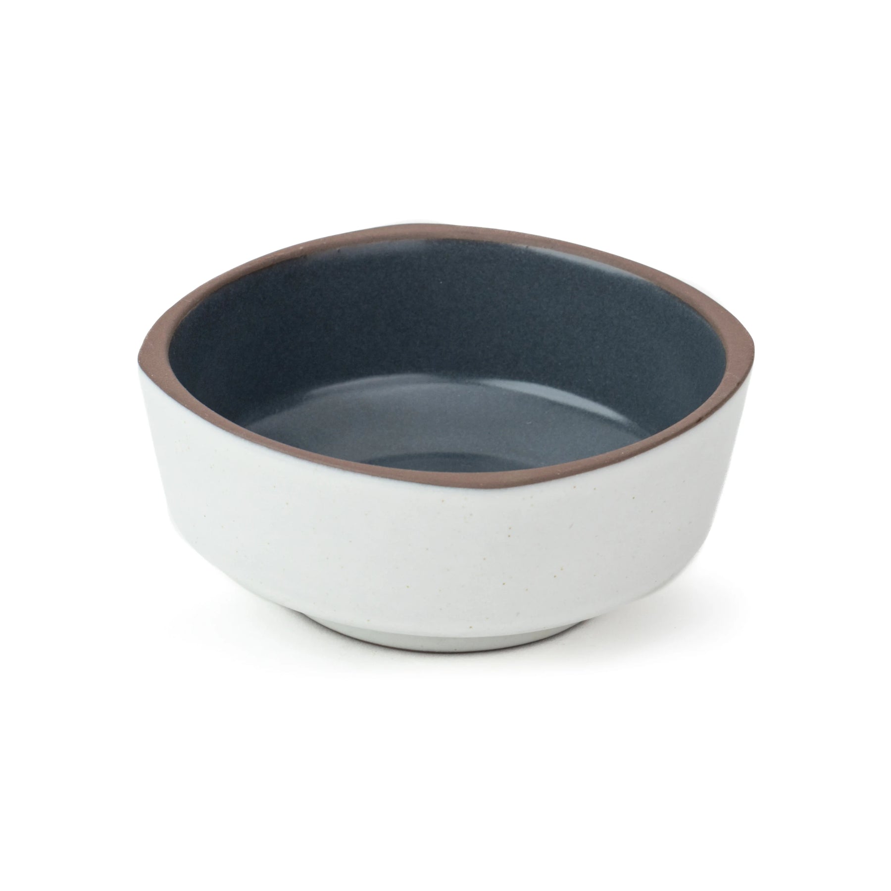 Ceramic bowl with blue interior and white exterior on a white background
