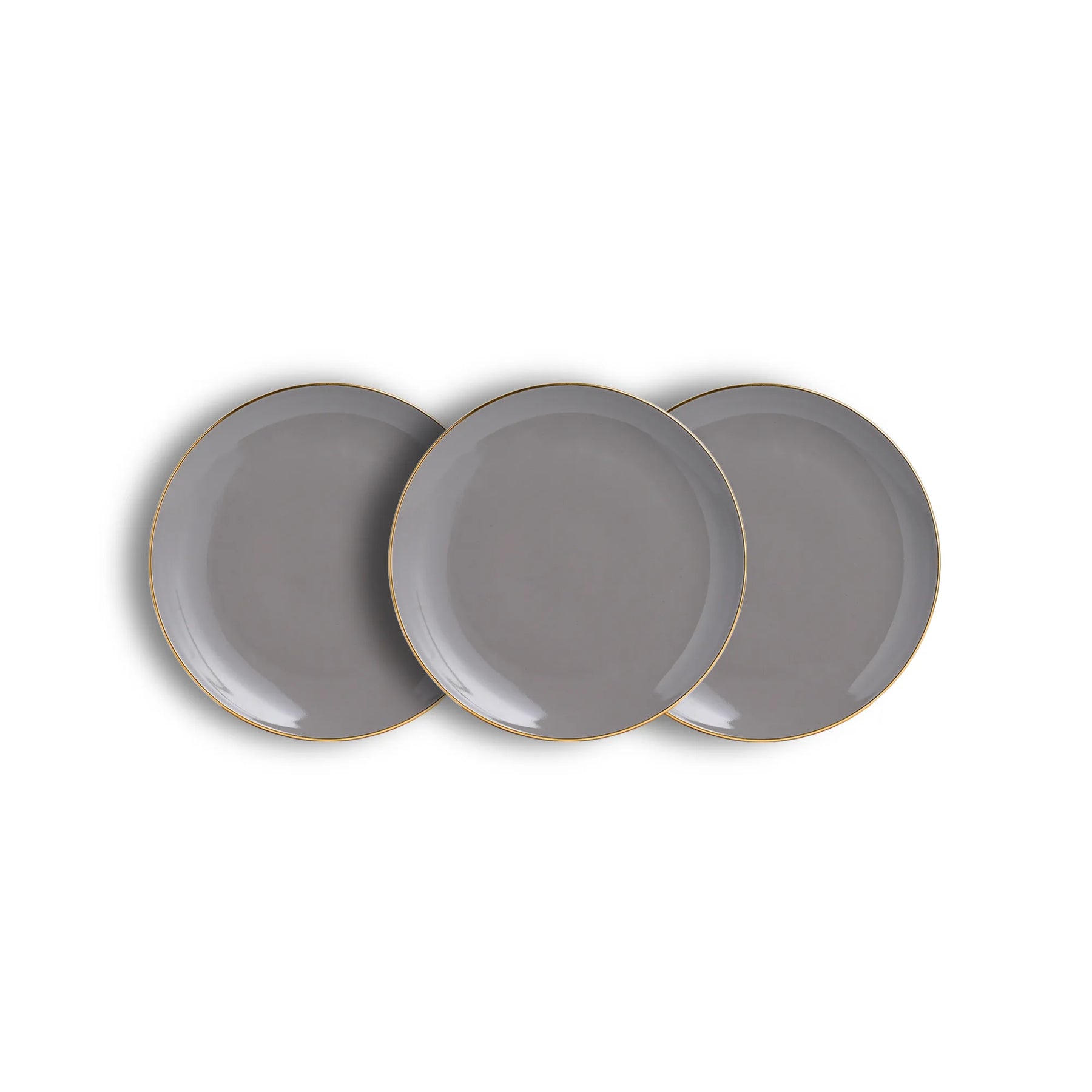 Three gray plates with gold rims on a white background