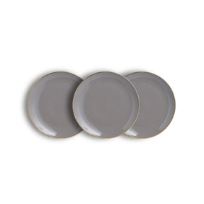 Three gray plates with gold rims on a white background