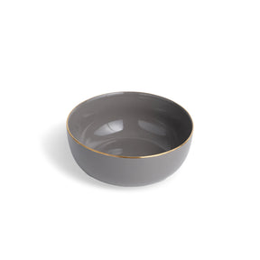 Gray ceramic bowl with gold rim on a white background