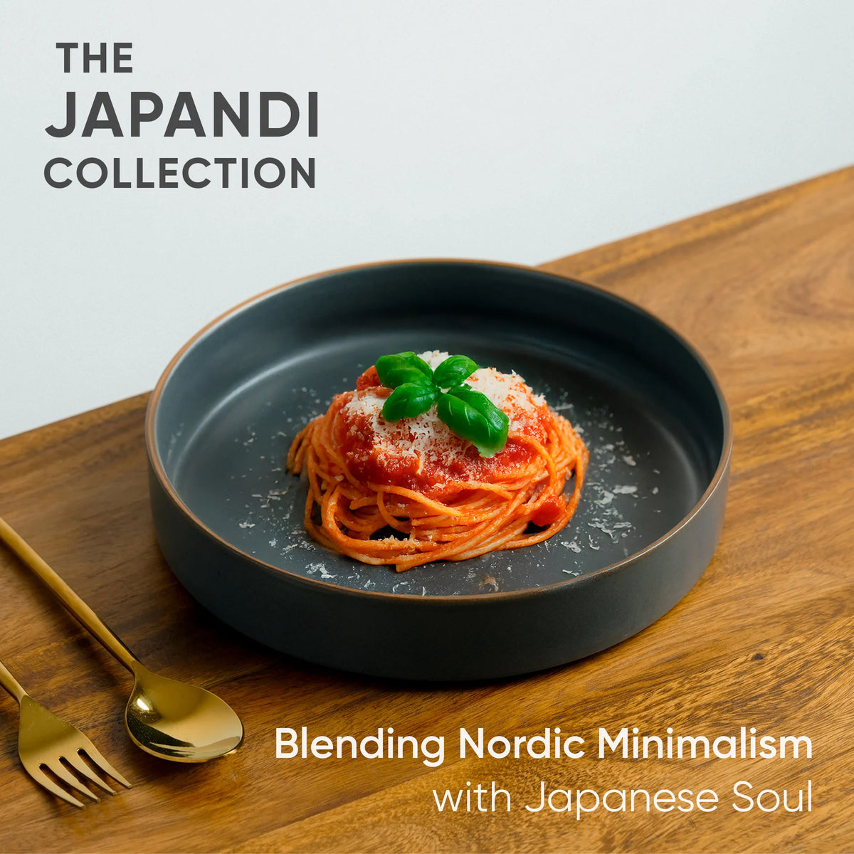 Spaghetti dish on a dark plate with gold fork and spoon on a wooden surface, featuring 'The Japandi Collection' text.