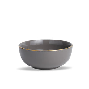 Gray ceramic bowl with gold rim on a white background