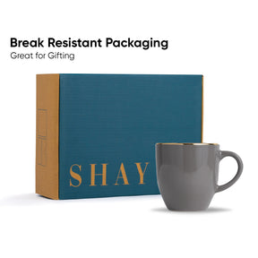 Gray mug with 'SHAY' branding next to a blue box labeled 'Break Resistant Packaging'.