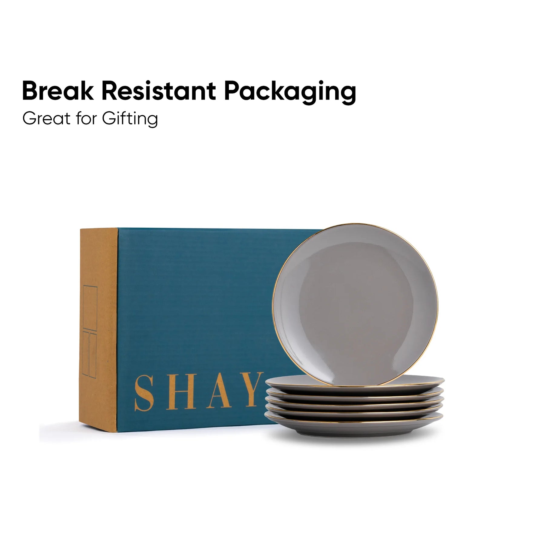 Set of gray plates in front of a 'SHAY' branded box with text about break-resistant packaging.