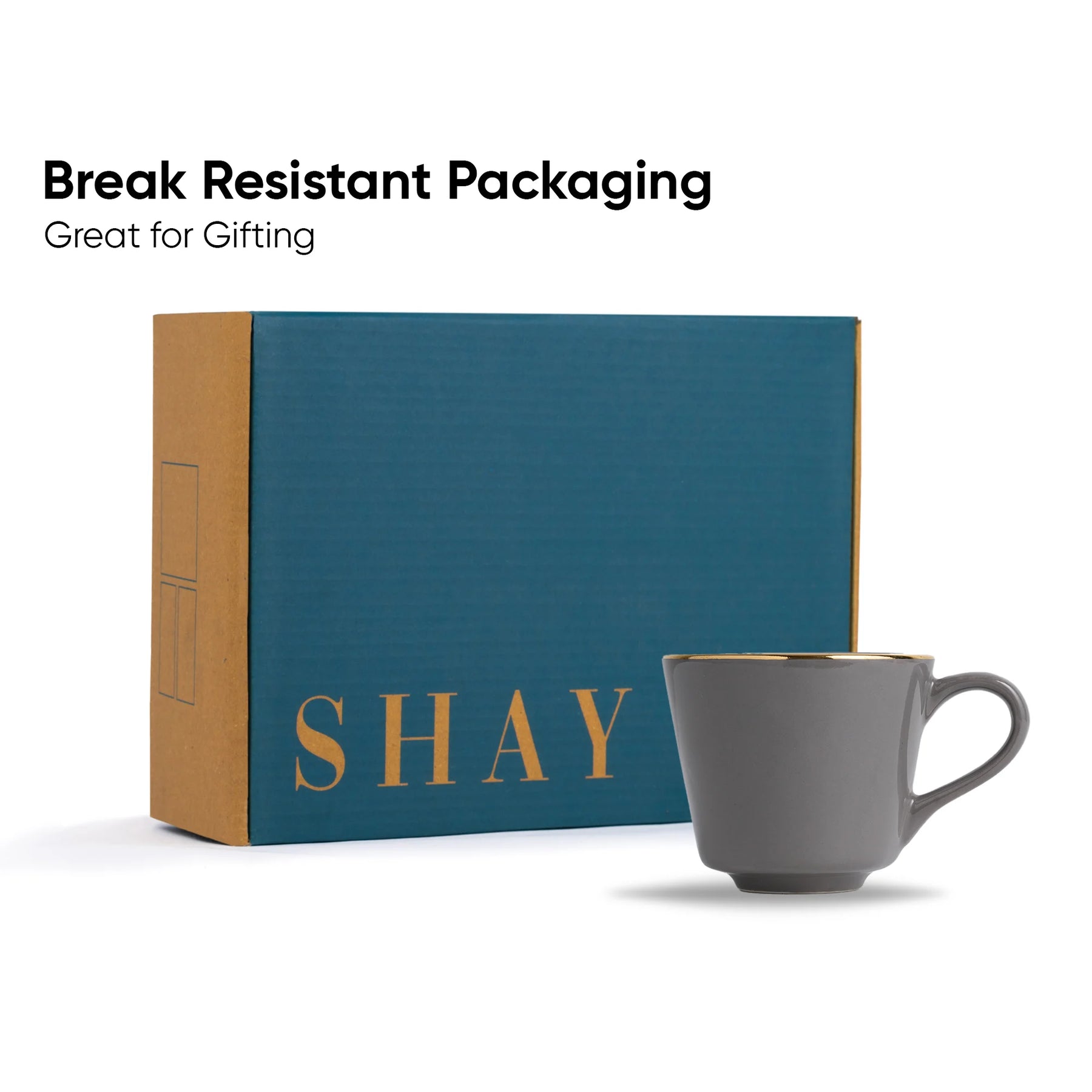 Gray mug in front of a blue box with 'SHAY' branding, labeled 'Break Resistant Packaging'.