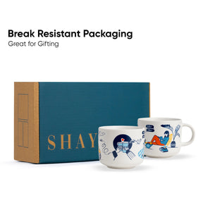 Two mugs with artistic designs on a blue box labeled 'SHAY'. Text 'Break Resistant Packaging Great for Gifting' above.