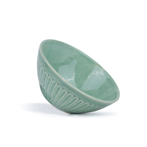 Green ceramic bowl on a white background