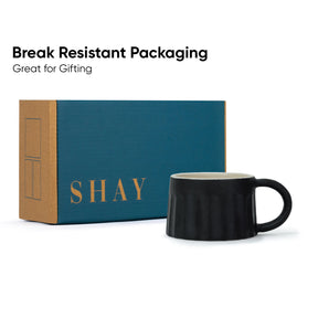 Black mug with 'SHAY' branded box on a white background