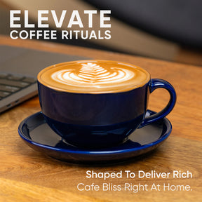 Blue cup of cappuccino on a wooden table with laptop, 'Elevate Coffee Rituals' text.