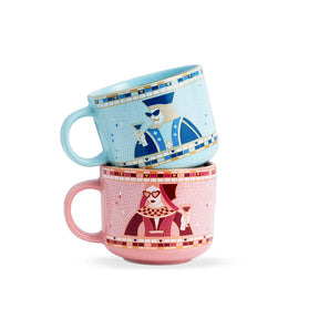 Two decorative mugs stacked on a white background
