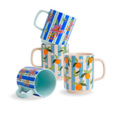 Set of four mugs with floral and fruit patterns on a white background