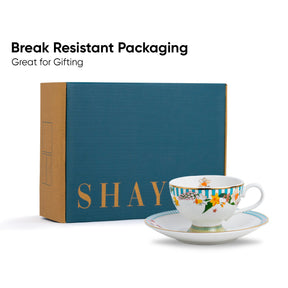 Tea cup and saucer with 'SHAY' branding in front of a blue box labeled 'Break Resistant Packaging'.