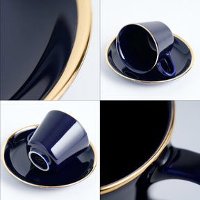 Navy blue ceramic cup and saucer with gold trim on a white background