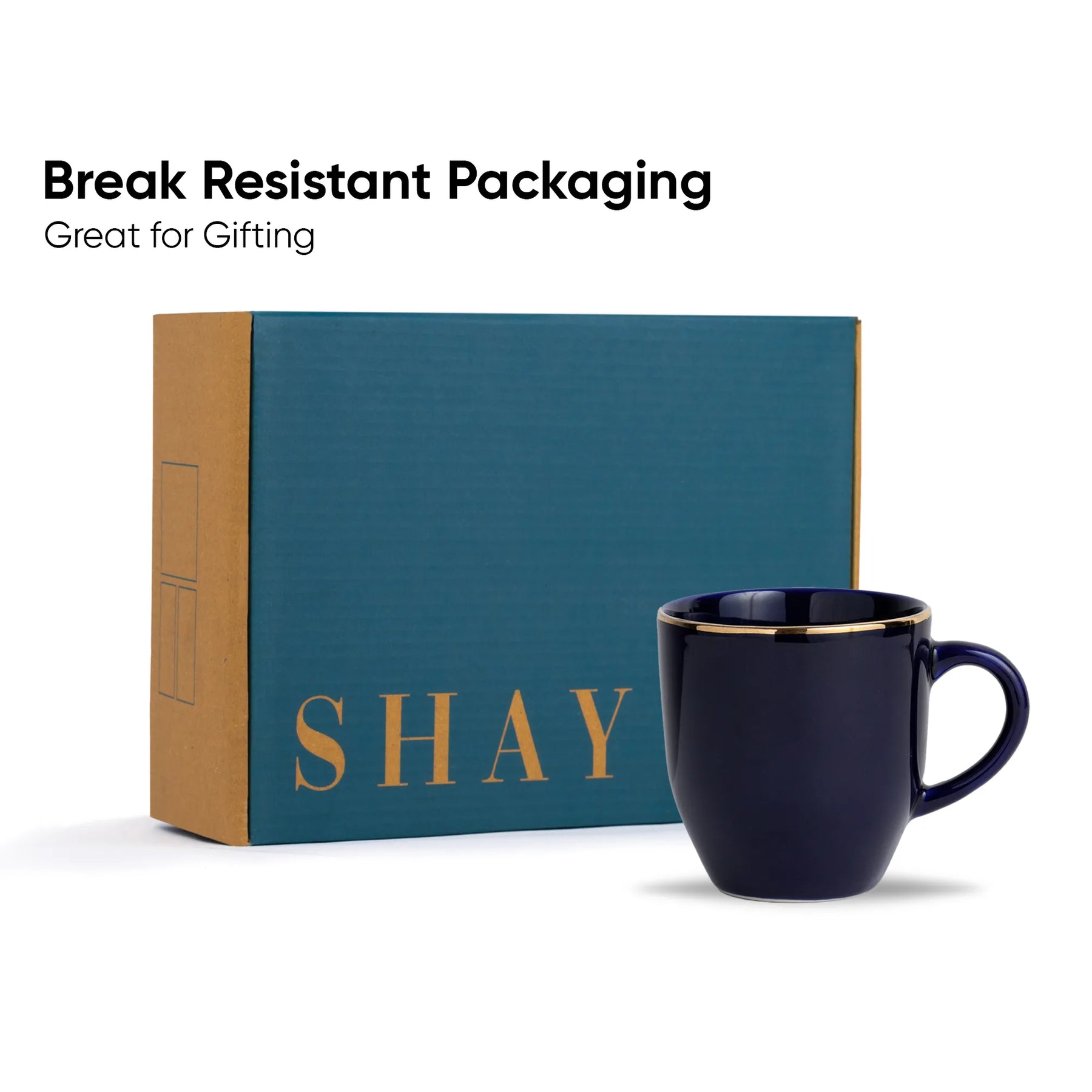 Navy mug with gold rim in front of a teal box labeled 'SHAY' on a white background.