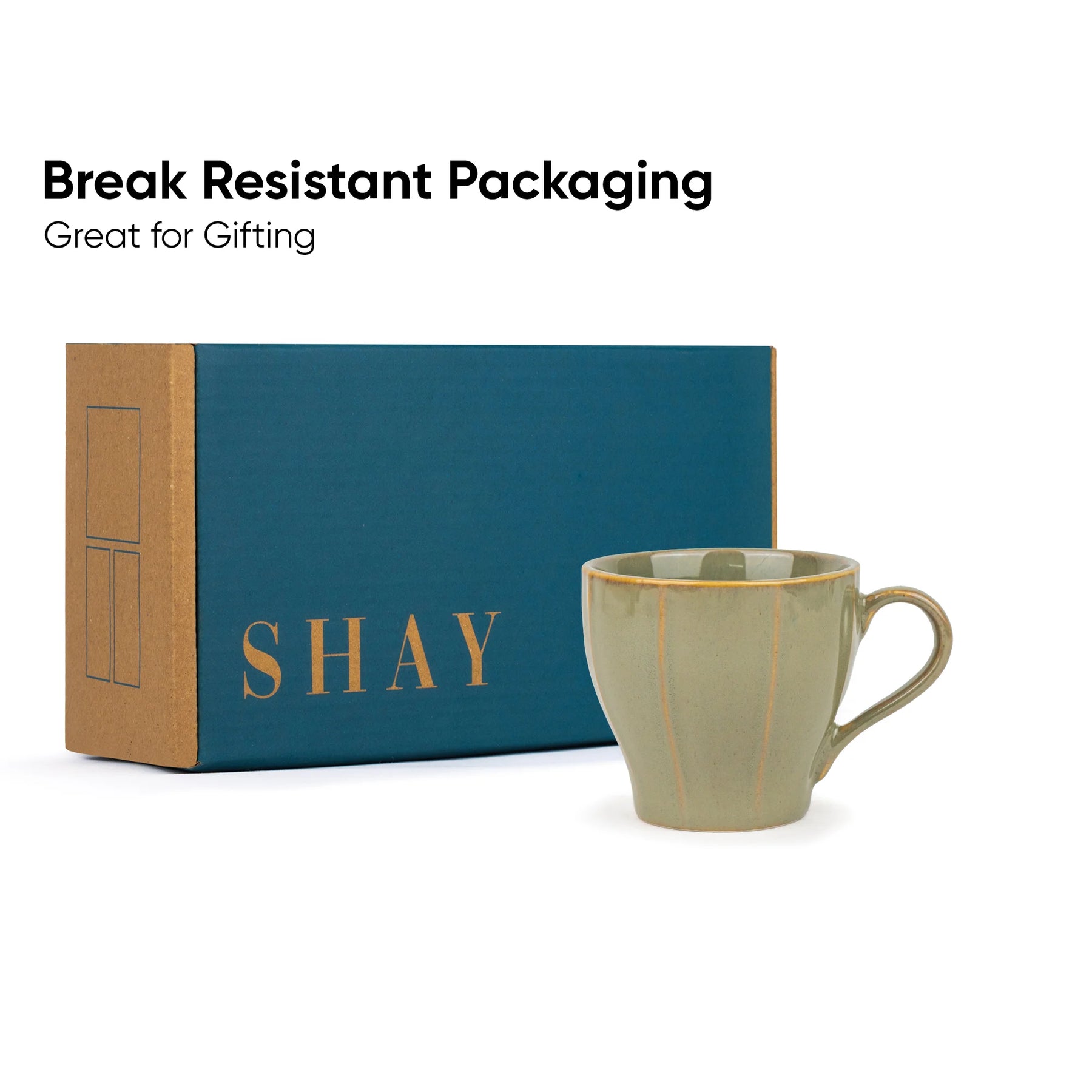 Green mug with 'SHAY' branding next to a blue and brown box on a white background.
