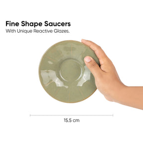 Hand holding a green ceramic saucer with text about fine shape saucers and reactive glazes.