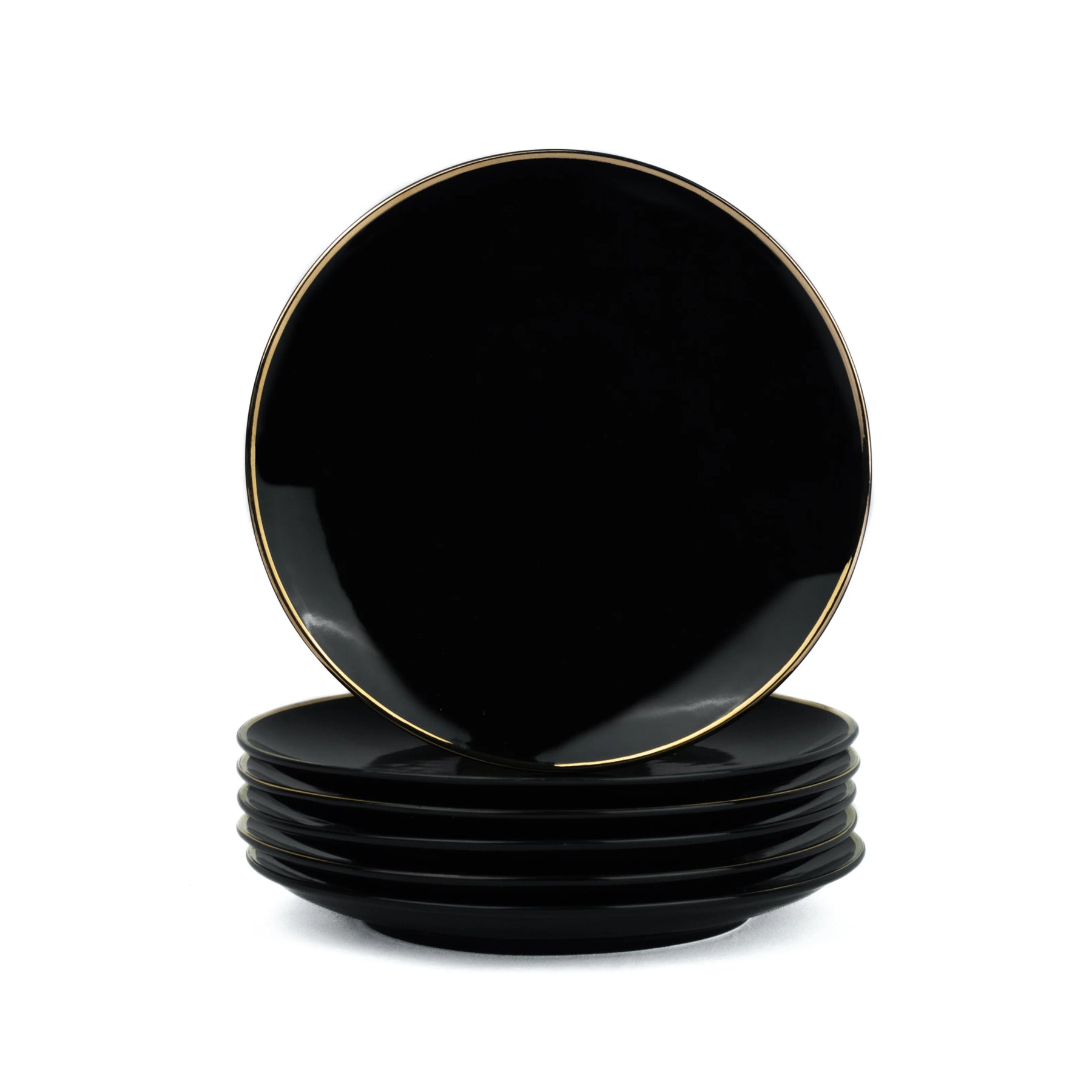Set of black plates with gold rims on a white background